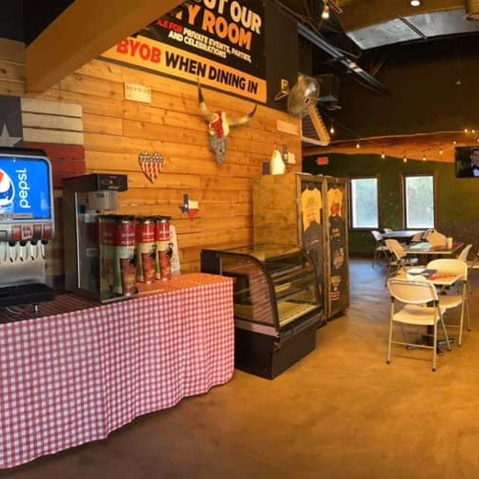 Interior of Cesar's Snack Shack with a Pepsi fountain, snack display, and dining tables.